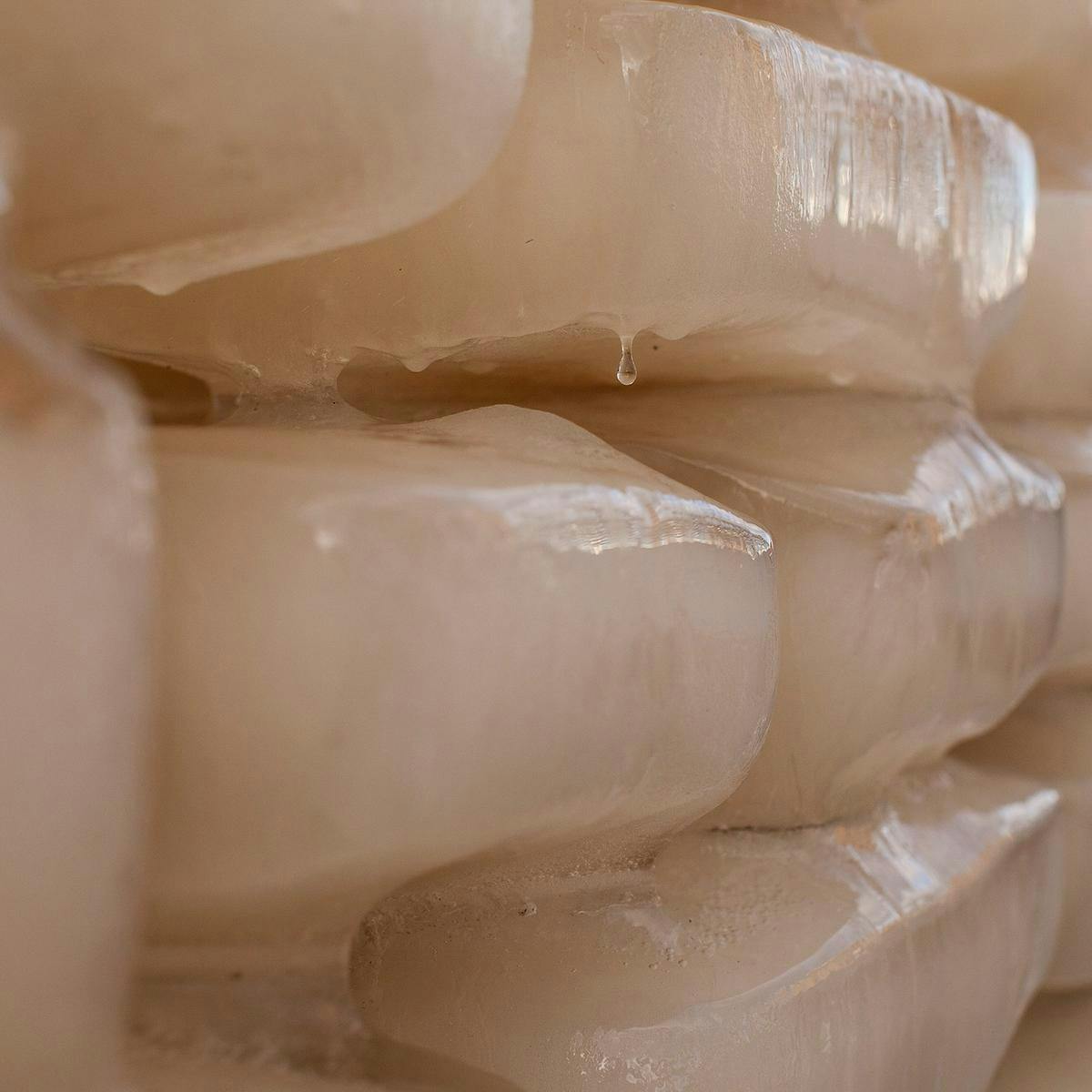 A close-up of stacked melting ice bricks.