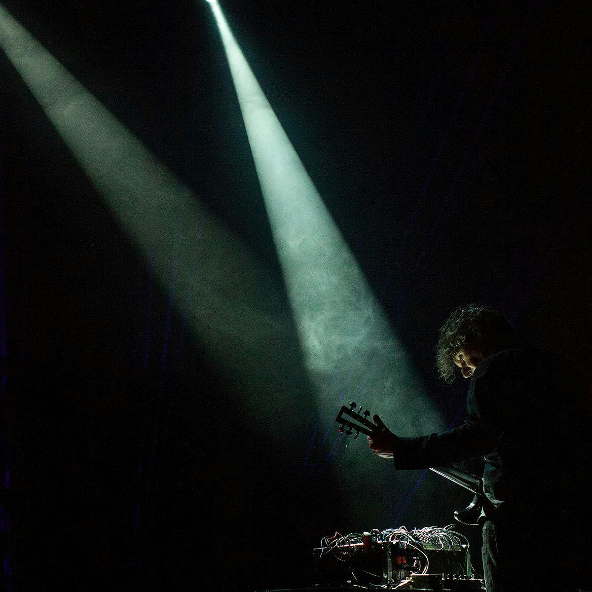 Marco Fusinato performs a guitar on-stage.